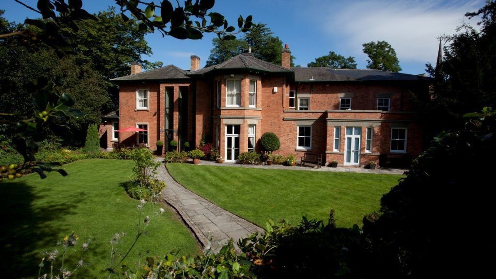 Rear view featuring landscaped gardens